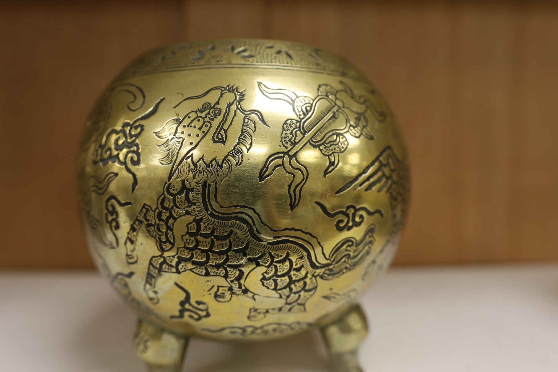 A Chinese bronze globular dragon decorated censer and cover on three legs, Xuande mark, early 20th century, 20cm high. Condition - good